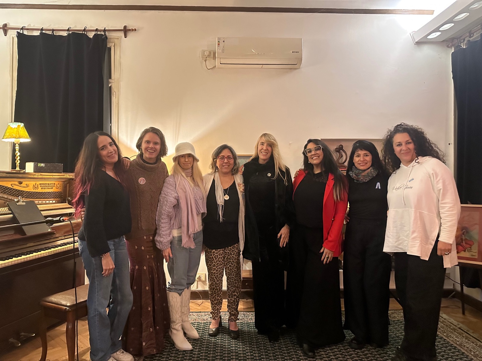 Womxn on Stage — group portrait by the piano at Casa Arias, Buenos Aires, Argentina