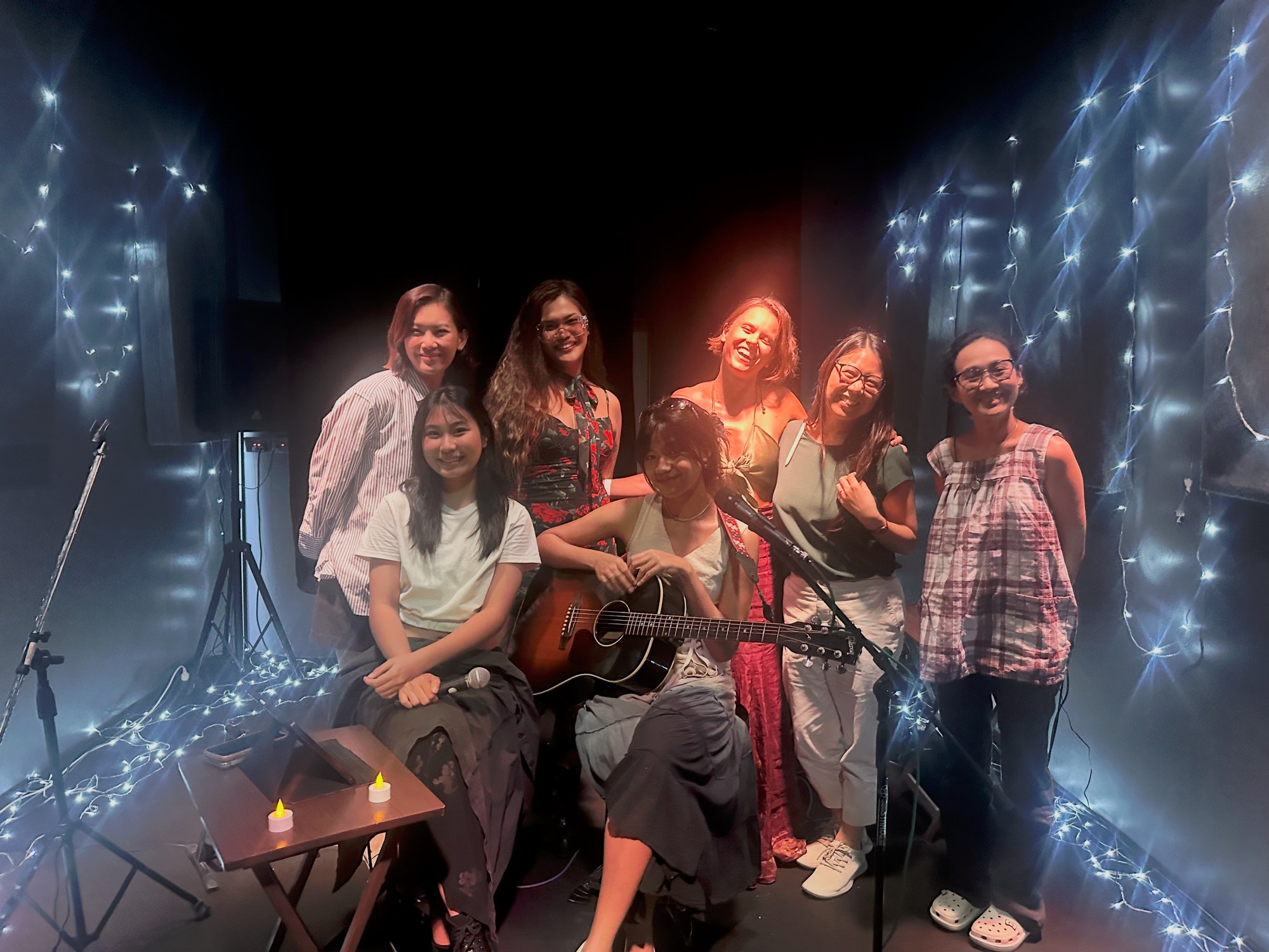 Womxn on Stage — performers on stage with guitar and fairy lights at Art House Lat Phrao, Bangkok