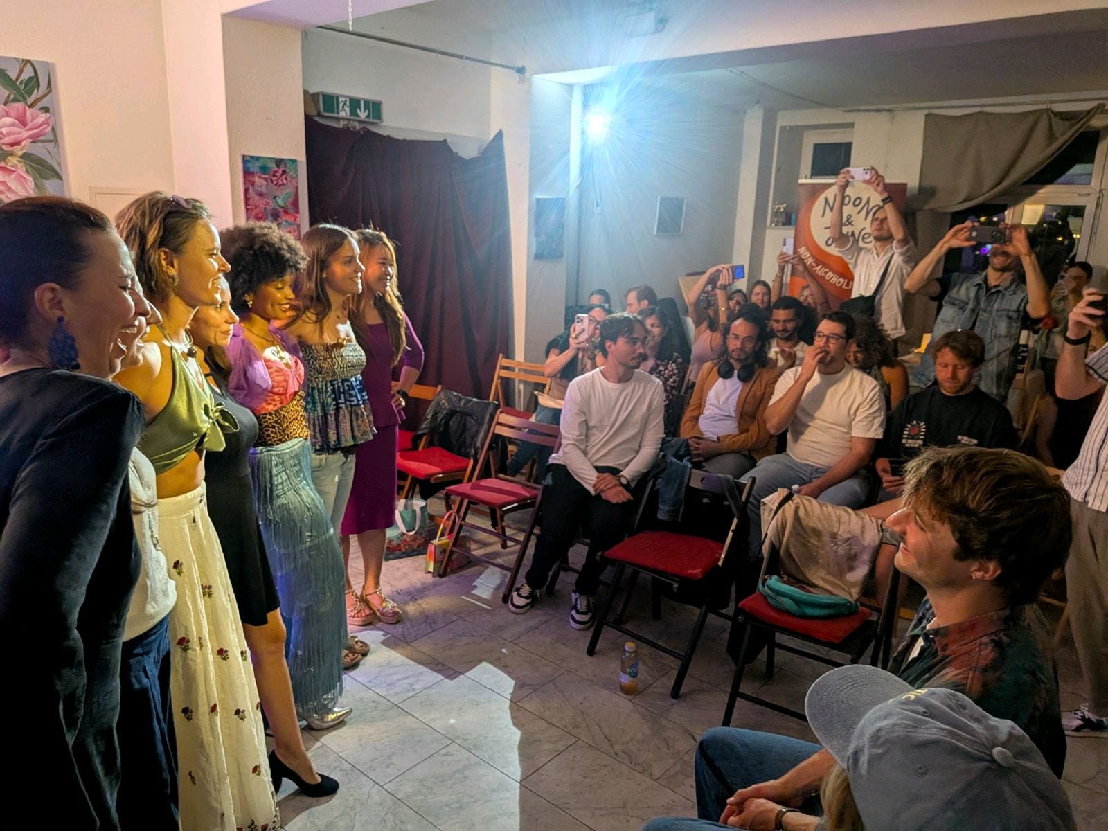 Womxn on Stage — cast facing a packed audience at the Zurich Homecoming edition, Ekstase